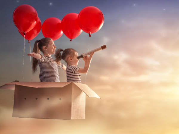 Two Kids Flying in Box with Floating Ballons
